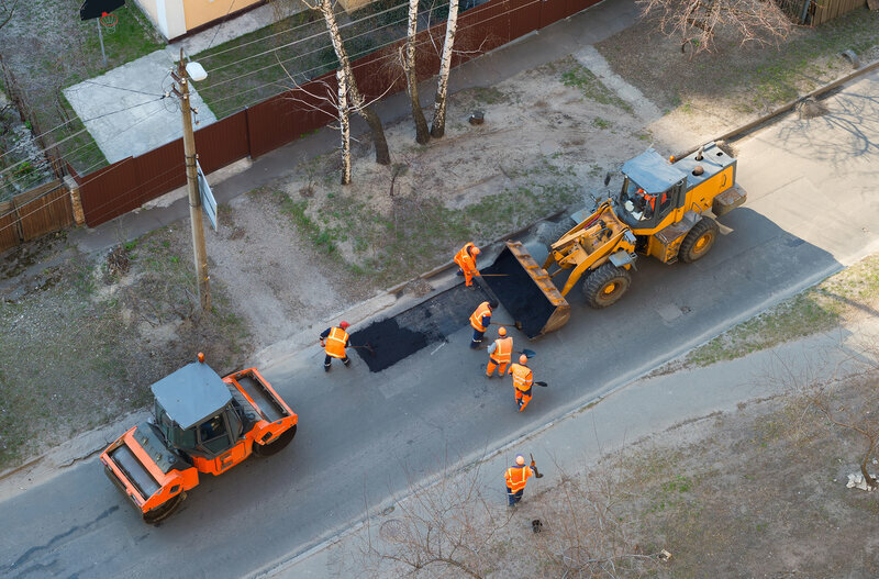 fixing road, asphalt, excavator people