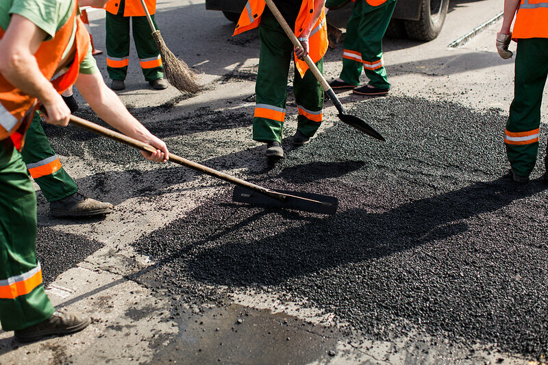 Workers On Asphalting Paver Machine During Road Street Repairing